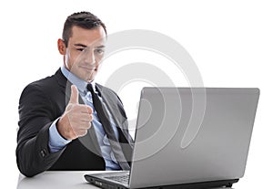 Business: successful man giving thumbs up sitting at desk in fro