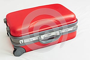 Business suitcase, red color on bed