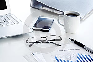 Business table with laptop and coffee