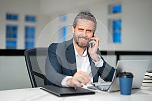 Business talk on phone. Ofice employee remote working in modern office. Businessman on remote meeting, working online in
