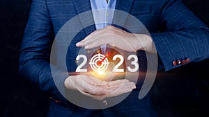 Business target and goal 2023 icon, hand pointing holding 2023 virtual screen, Start new year 2023 with a goal plan, action plan,