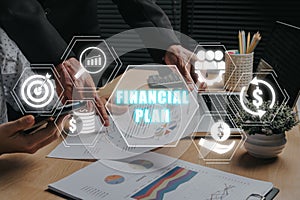 Business team analyzing income charts and graphs with financial plan icon on virtual screen