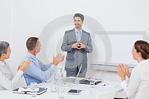 Business team applauding their colleague