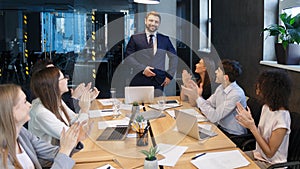 Business team applauding to leader, congratulating with project