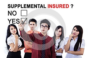 Business team approving supplemental insured