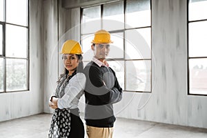 Business team back to back crossed their arm and wearing hardhat