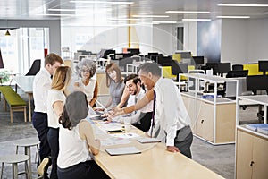 Business team brainstorm in open plan office, elevated view