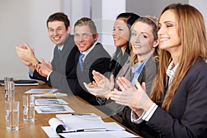 Business team calpping hands during meeting