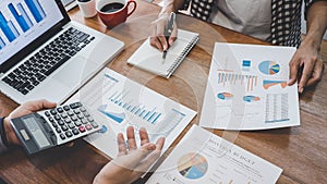 Business team casual collaboration discussing working analysis with financial data and marketing growth report graph in team,