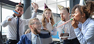 Business team celebrating a birthday of collegue in the modern office photo