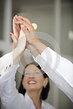 Business team celebrating success with high five