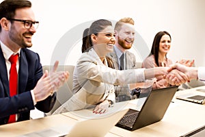 Business team clapping hands during a meeting