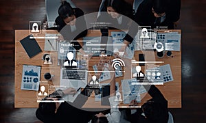 Business Team Collaborating on Data Analytics Project with Digital Interface Elements and Graphs on a Modern Office