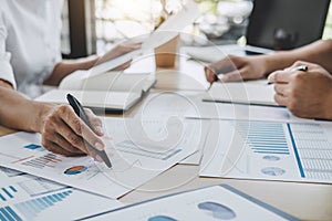 Business team colleagues discussing working analysis with financial data and marketing growth report graph in team, Meeting