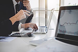 Business team colleagues working with computer, laptop, discussing and analysis graph stock market trading with stock chart