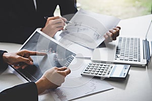 Business team colleagues working with computer, laptop, discussing and analysis graph stock market trading with stock chart data,