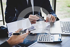 Business team colleagues working with computer, laptop, discussing and analysis graph stock market trading with stock chart data,