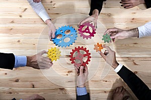 Business team connect pieces of gears. Teamwork, partnership and integration concept