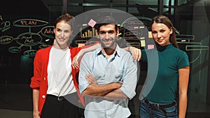 Business team crossing arms while standing together at glass wall. Tracery