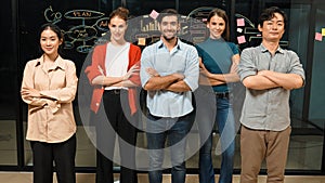 Business team crossing arms while standing together at glass wall. Tracery