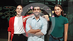 Business team crossing arms while standing together at glass wall. Tracery