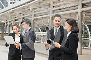 Business team discuss project in town