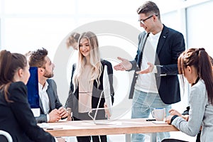 business team discussing work issues near the desktop .