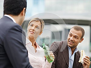 Business Team Enjoying Lunch Break Eating Sandwich Outdoors