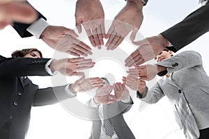 Business team with folded their hands in a circle