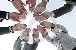 Business team with folded their hands in a circle