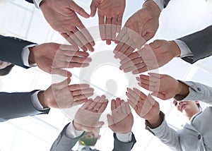 Business team with folded their hands in a circle