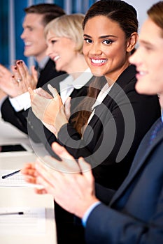 Business team of four applauding