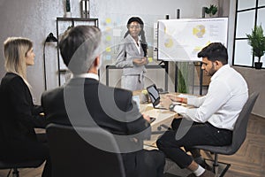 Business team of four good-looking experienced multiethnic corporate workers
