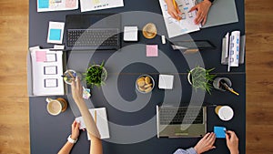 Business team with gadgets working at office table