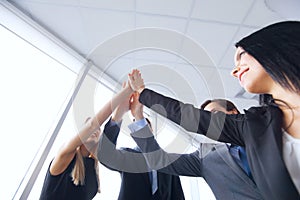 Business team giving high five in office