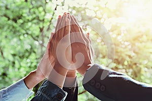 business team giving high five with sunshine background