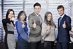 Business team giving thumbs up