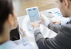 Business team with graph on tablet pc screen