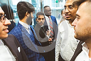 Business team group going on elevator. Business people in a large glass elevator in a modern office. Corporate