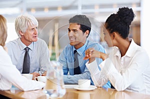 Business team having happy conversation. Portrait of multi ethnic business team having happy conversation at conference