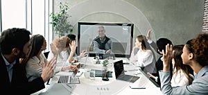 Business team having video call with senior boss at office