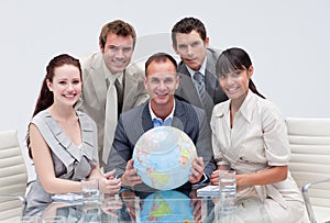 Business team holding a terrestrial globe photo