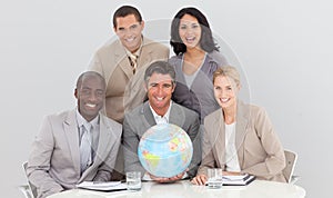 Business team holding a terrestrial globe