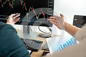 Business team investment Entrepreneur Trading discussing and analysis graph stock market in traders office. Business financial