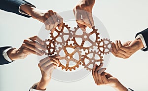 Business team joining cogwheel in circular together. Shrewd