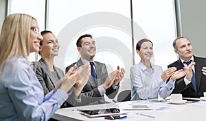 Business team with laptop clapping hands