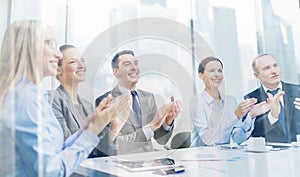 Business team with laptop clapping hands