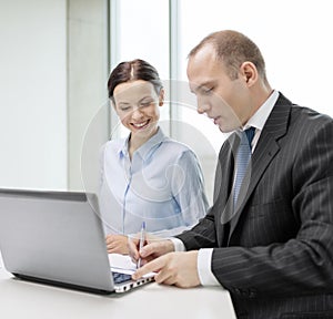 Business team with laptop having discussion