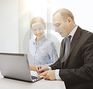 Business team with laptop having discussion