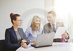 Business team with laptop having discussion